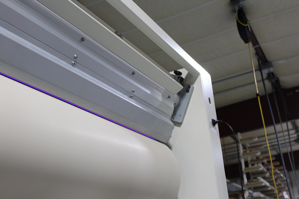 corona discharge of a QC covered roll corona treater