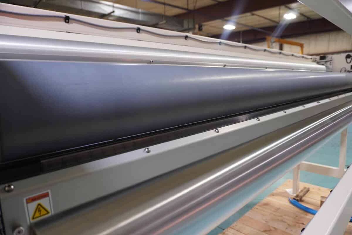 Ceramic coated roll in covered roll corona treatment system